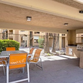 a patio with a table and chairs